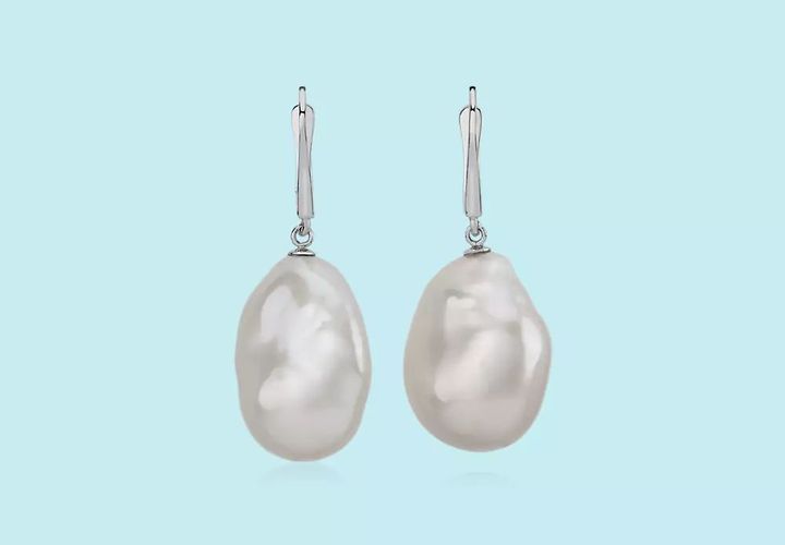 A pair of baroque pearl drop earrings featuring irregular, oblong, non-spherical shapes dangling from white gold lever-back clasps